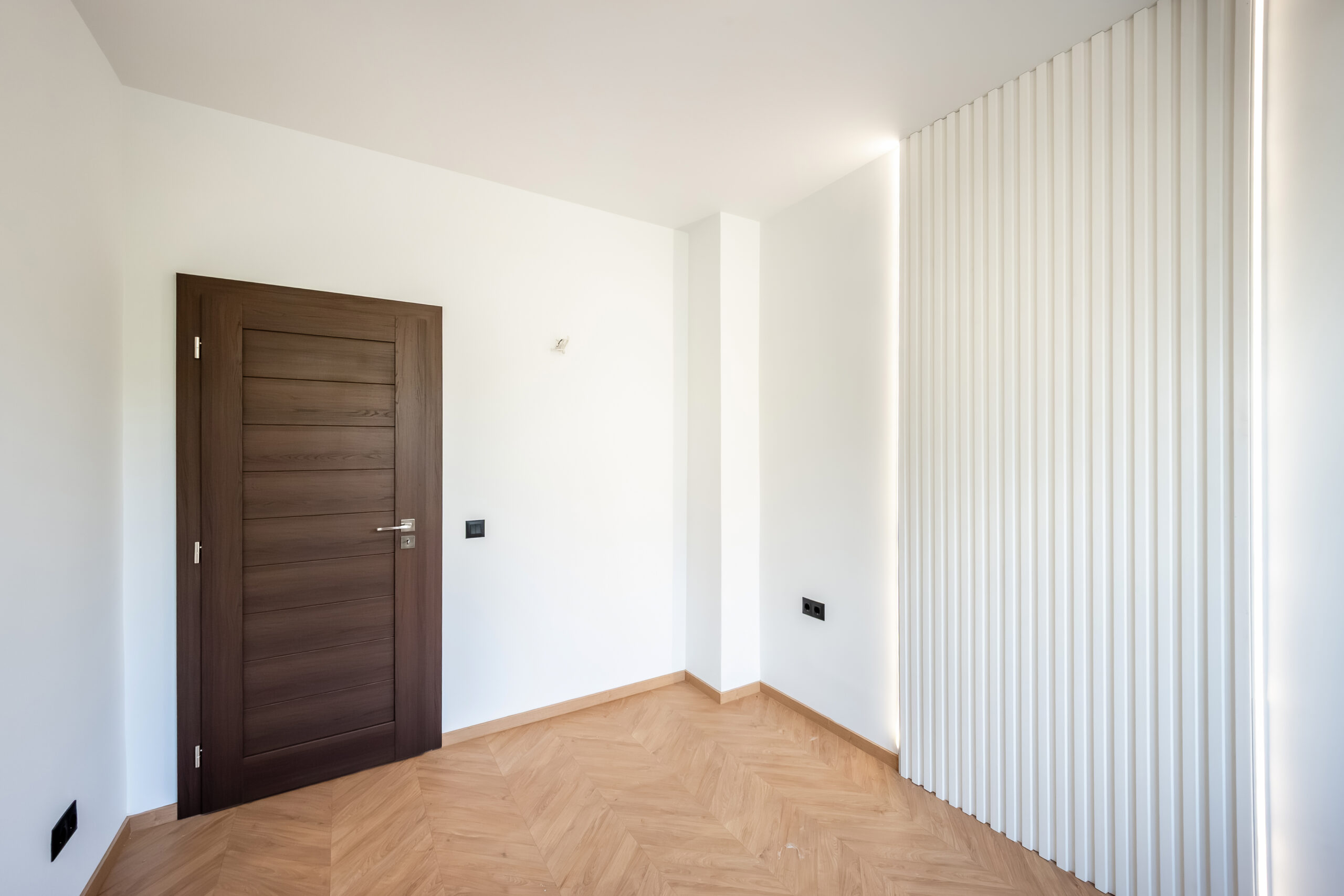 Modern bedroom with herringbone flooring
